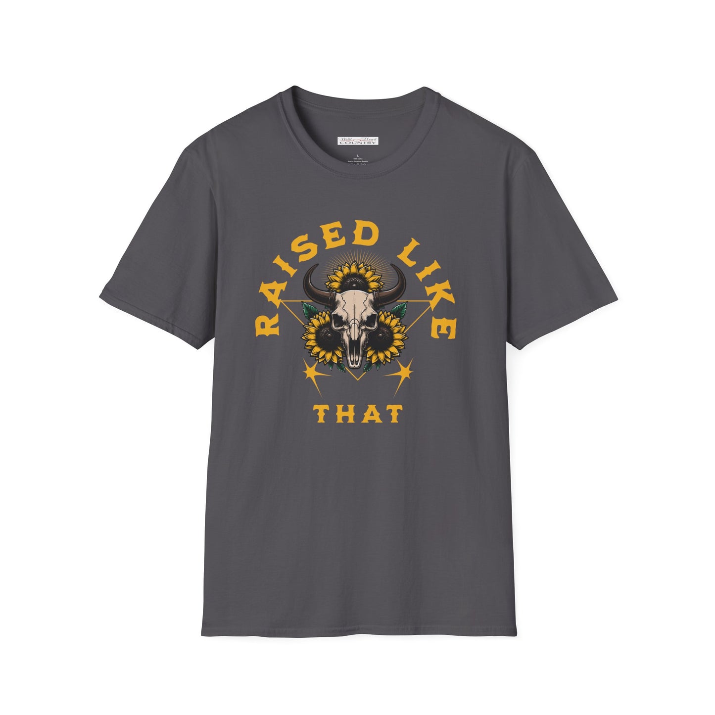 A T-shirt with the text 'RAISED LIKE THAT' and a graphic of a bull's skull and sunflowers, standing in a countryside setting with horses in the background.