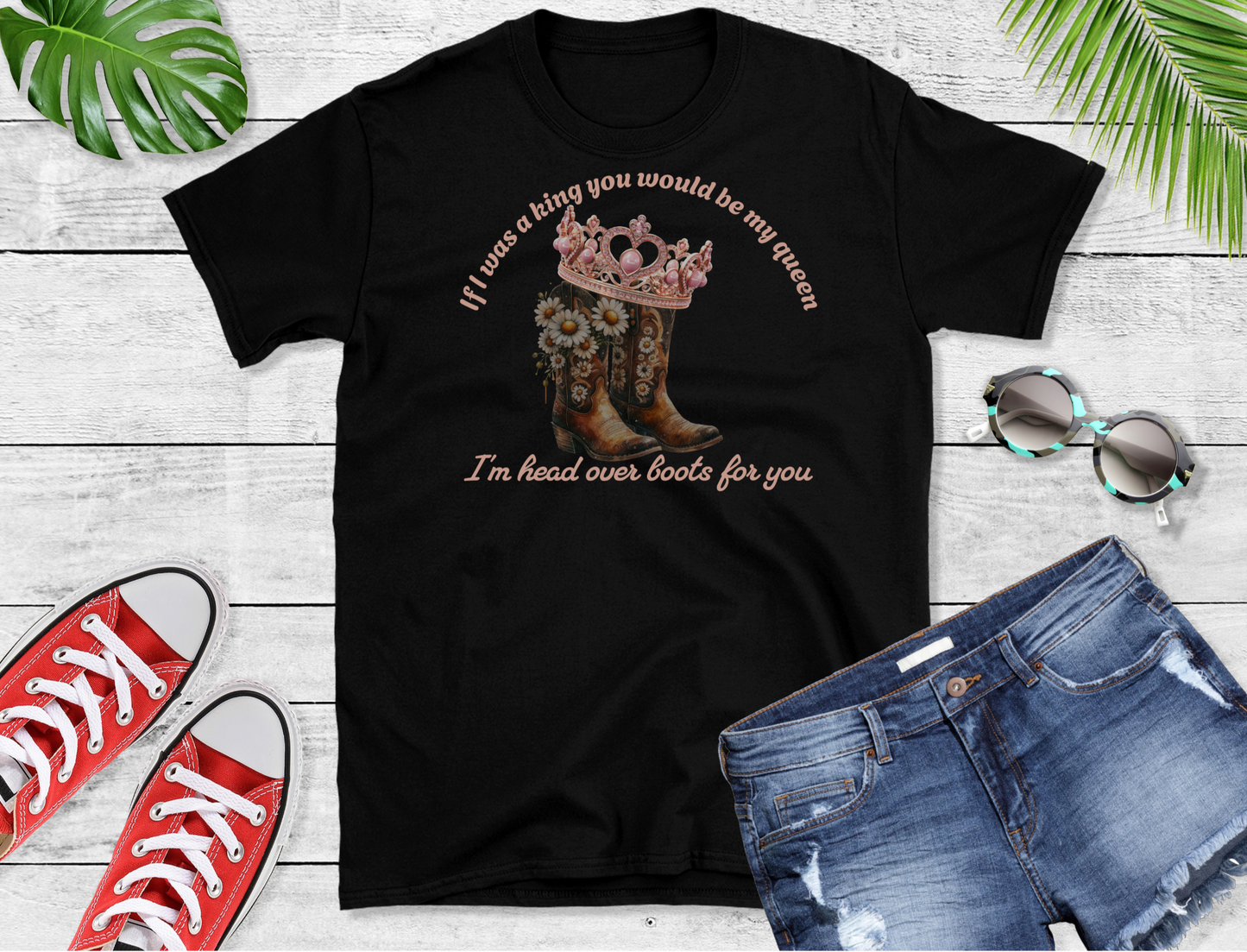This unique design features a pair of intricately detailed cowboy boots adorned with beautiful daisies, symbolizing rustic charm and romantic flair. Atop the boots sits a regal crown, adding a touch of royalty and elegance.
Surrounding the image, the heartfelt lyrics “If I was a King you would be my Queen” and “I’m head over boots for you”