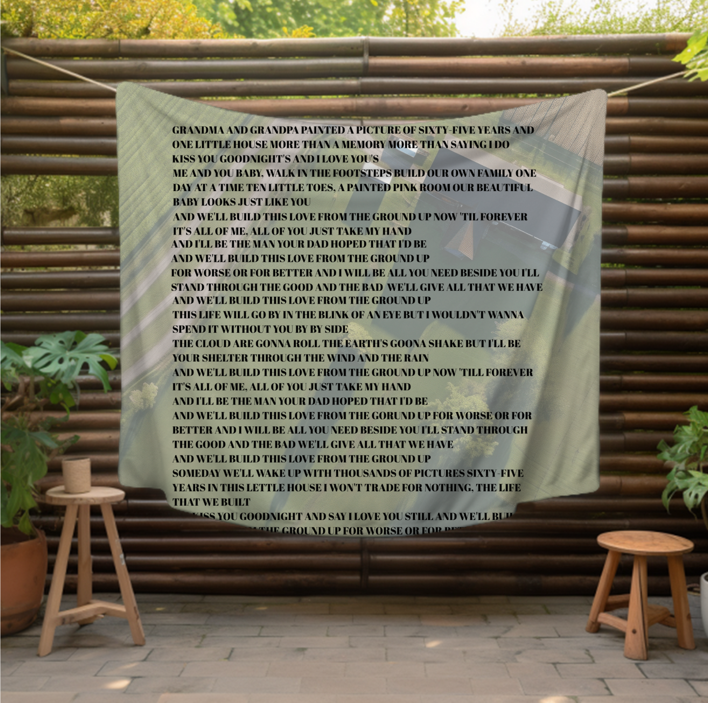 features an aerial view of a serene countryside home, symbolizing the foundation of love and family. Overlaid on this picturesque scene are the touching lyrics from Dan + Shay's song "From the Ground Up,"