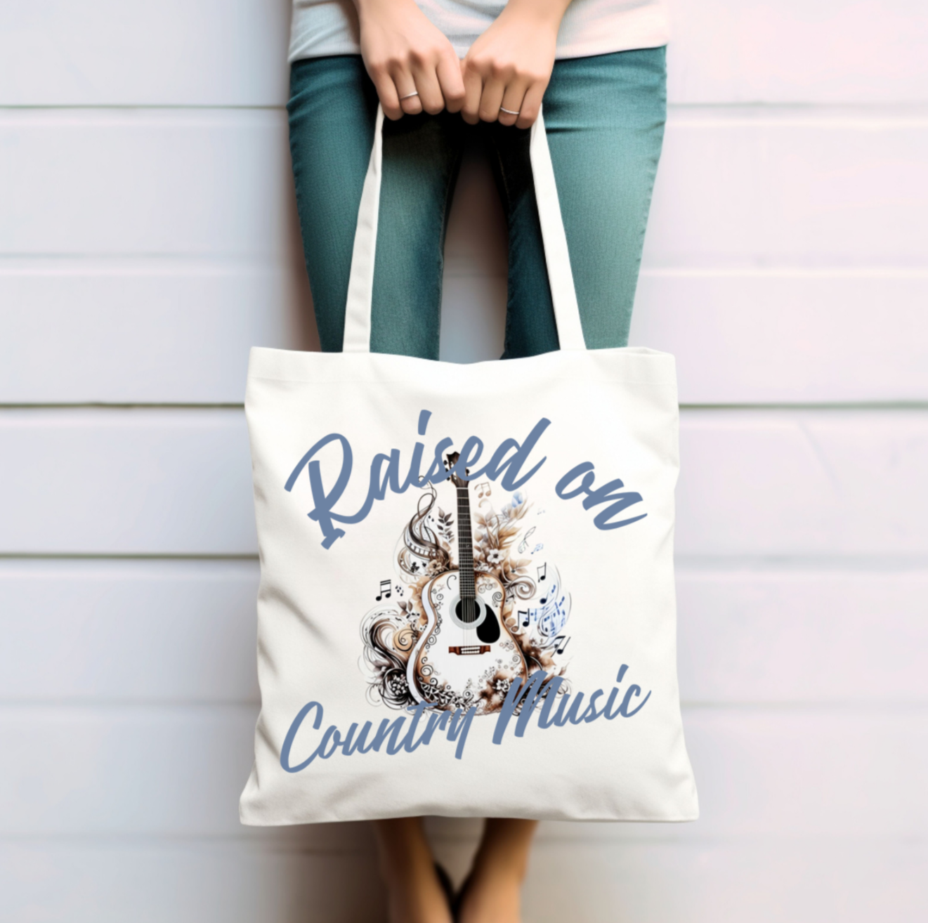Featuring a beautifully detailed acoustic guitar surrounded by intricate floral and musical elements, the bold script proudly declares “Raised on Country Music.