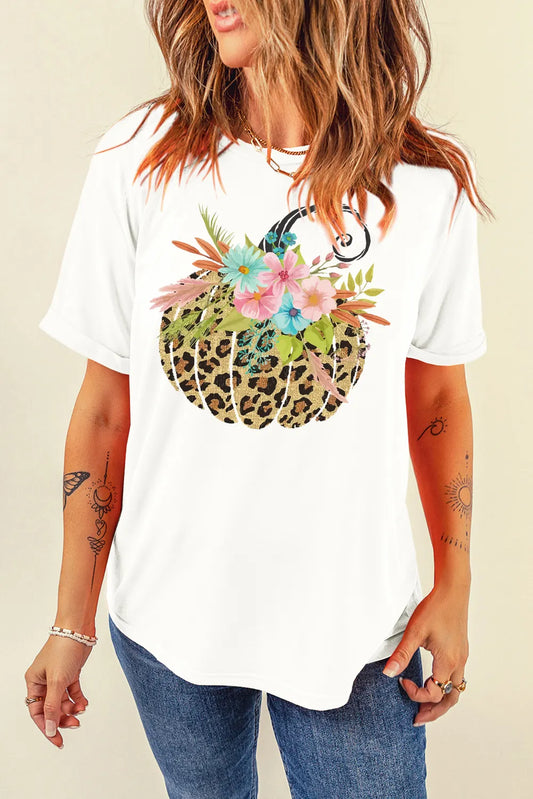 Person wearing a white t-shirt with a colorful graphic design on a beige background