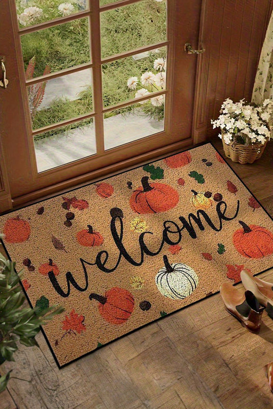 Decorative doormat with pumpkins and 'Welcome' text on a wooden floor.