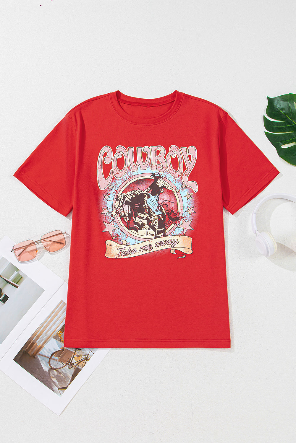 Red t-shirt with cowboy graphic design on a white background