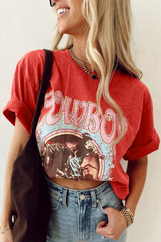 Person wearing a red 'Cowboy' graphic t-shirt with a plain background