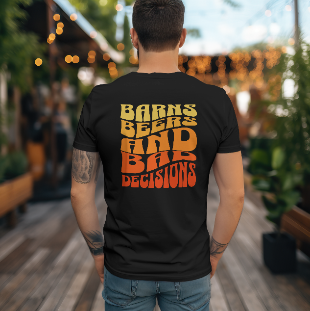 Person wearing a black t-shirt with yellow and red text in an outdoor setting