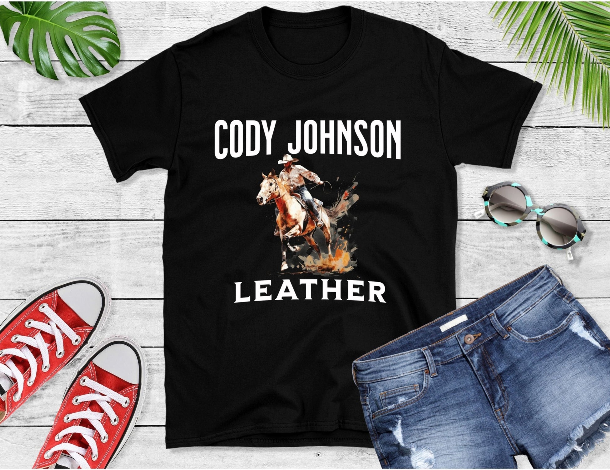 Watercolour art of a man riding a horse and white text Cody Johnson Leather