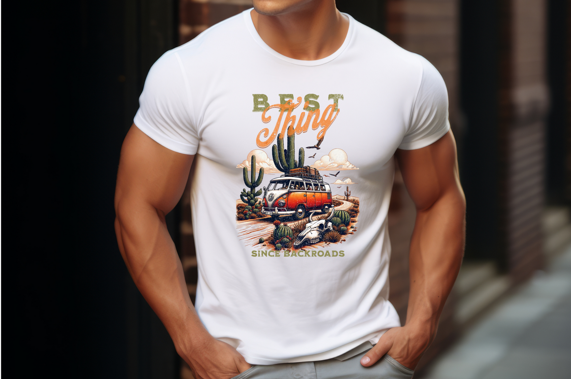 This design features a vintage Volkswagen van with a surfboard on top, cruising down a dusty desert backroad lined with majestic cacti and desert flora. The retro artwork, complete with an animal skull partially buried in the sand, captures the essence of adventure and freedom. The bold text “Best Thing Since Backroads” 
