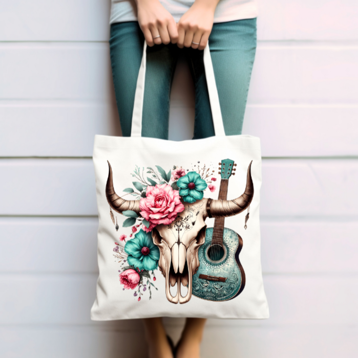 Unique artwork showcases a detailed bull skull adorned with vibrant pink and teal flowers, blending beautifully with a turquoise acoustic guitar at the heart of the design. 