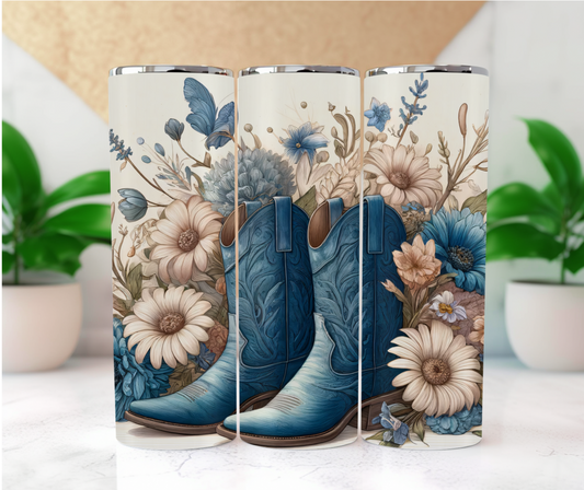 Featuring a beautifully detailed pair of embossed blue cowboy boots surrounded by a lush bouquet of soft, delicate flowers in shades of blue, cream, and peach