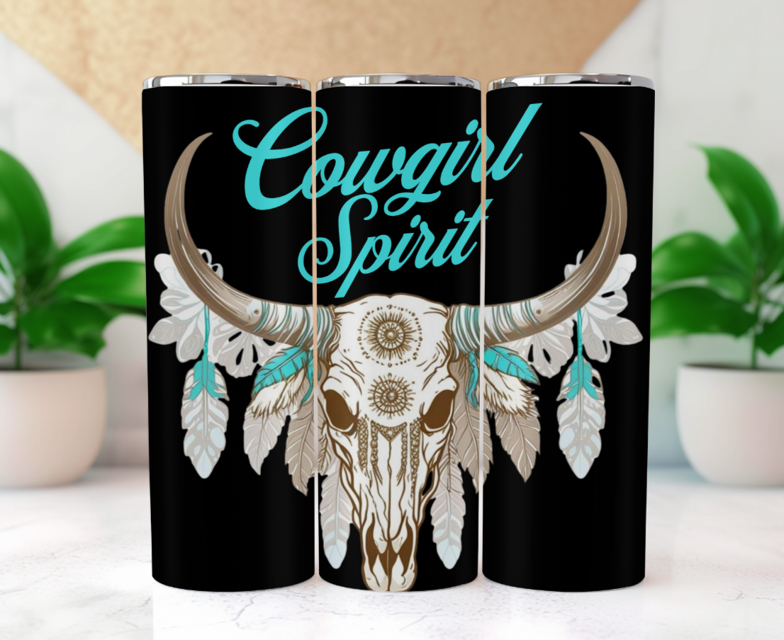Features a majestic longhorn skull adorned with intricate mandala patterns, surrounded by soft feathers in hues of beige, white, and turquoise. Topping it all off is the bold and elegant "Cowgirl Spirit" script in vibrant turquoise.