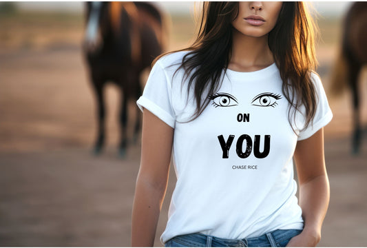 Graphics T-Shirt with the image of two eyes and in black text below "on you" Chase Rice