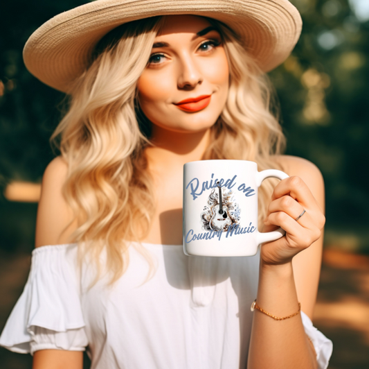 Featuring a beautifully detailed acoustic guitar surrounded by swirling floral and musical elements.  In bold, flowing script “Raised on Country Music”